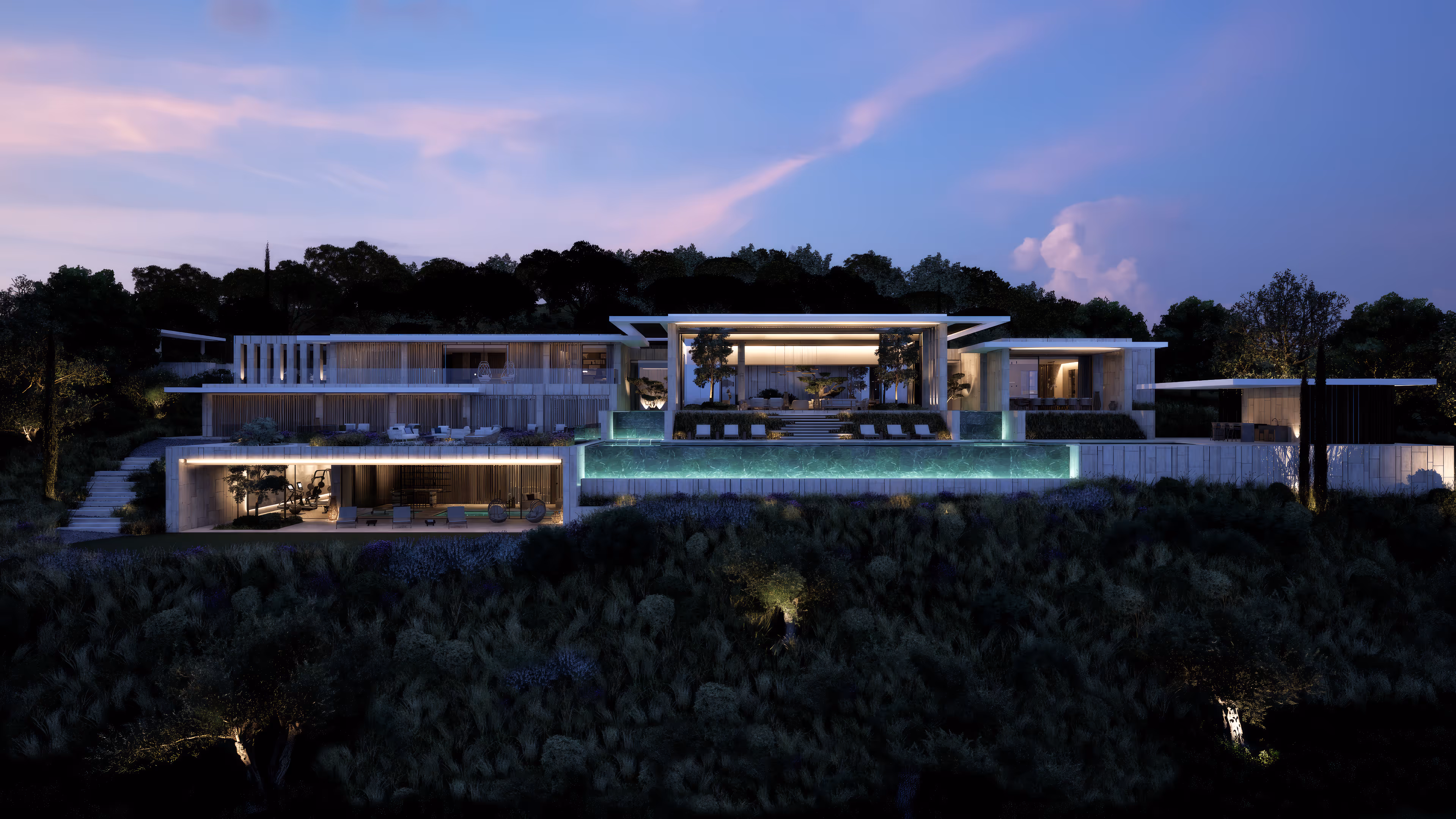 Modern luxury villa at dusk with illuminated terraces, infinity pool, and surrounding greenery.