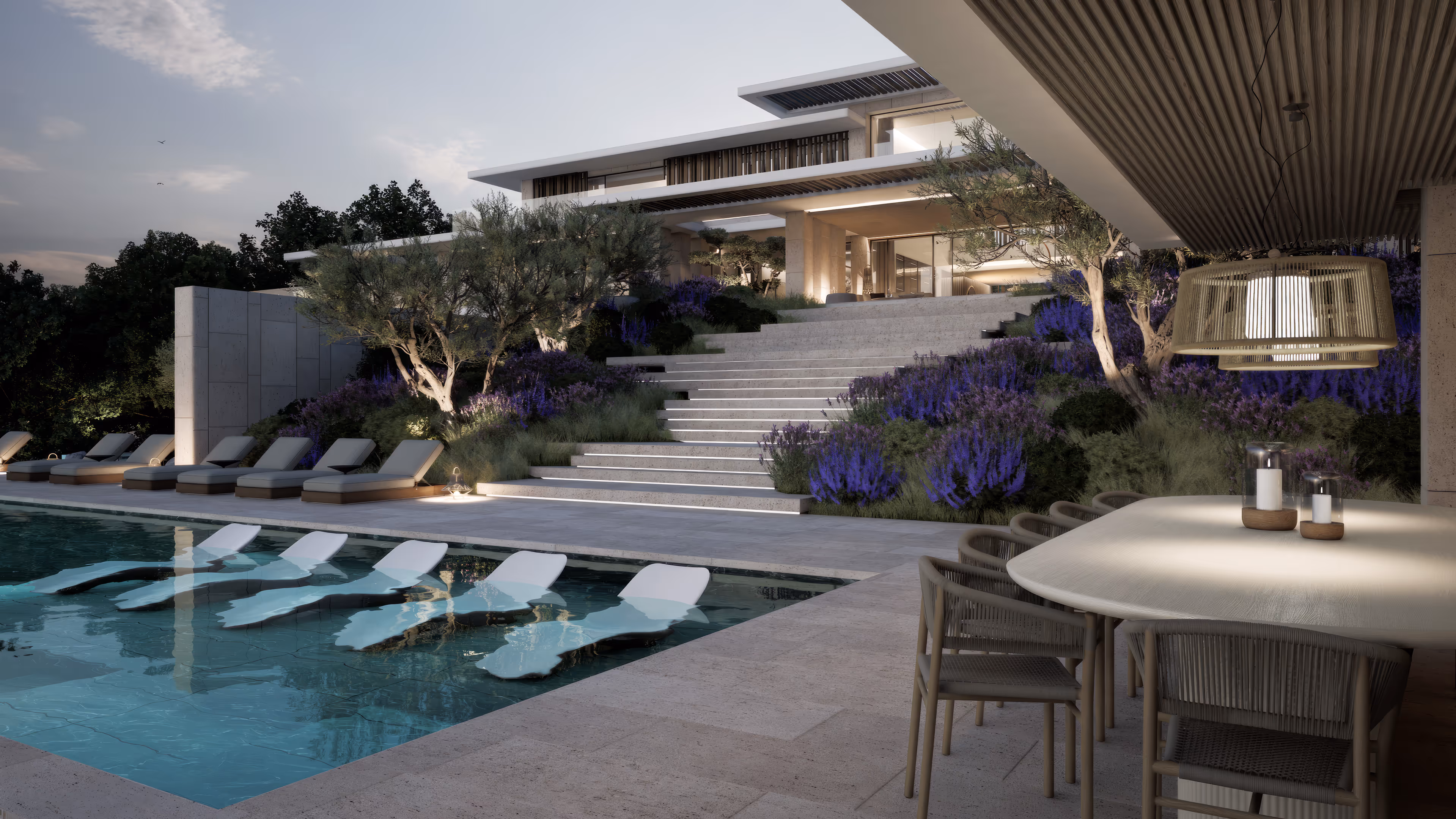 Modern luxury villa with an outdoor pool featuring submerged loungers, stone stairs, purple flowers, and a covered dining area with hanging light.